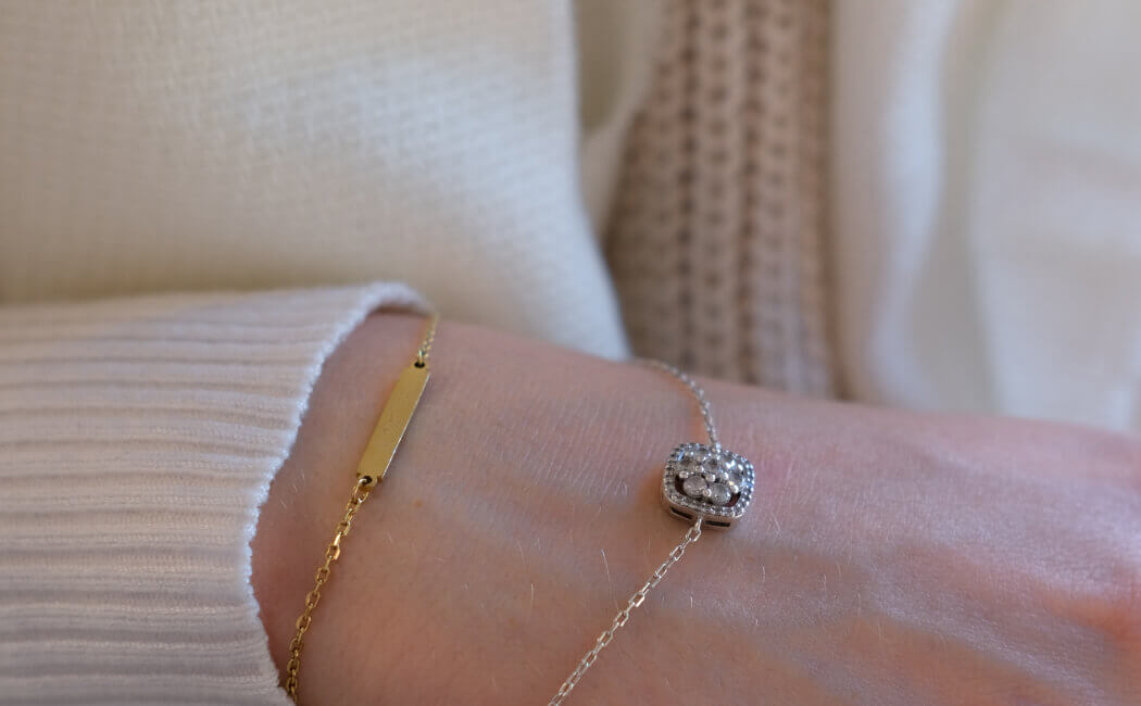 Layered gold-tone necklaces styled together