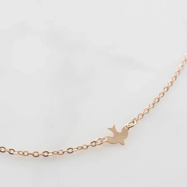 Gold bird pendant necklace