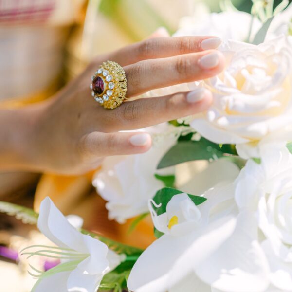 Gold-tone statement ring with red centre stone