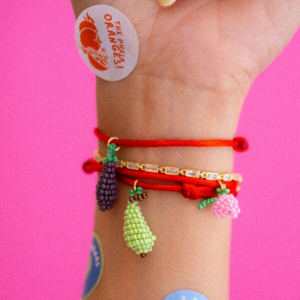 Red thread bracelet with beaded charms
