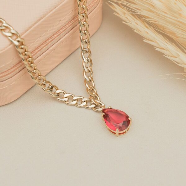 Chunky gold-tone chain necklace with red teardrop pendant