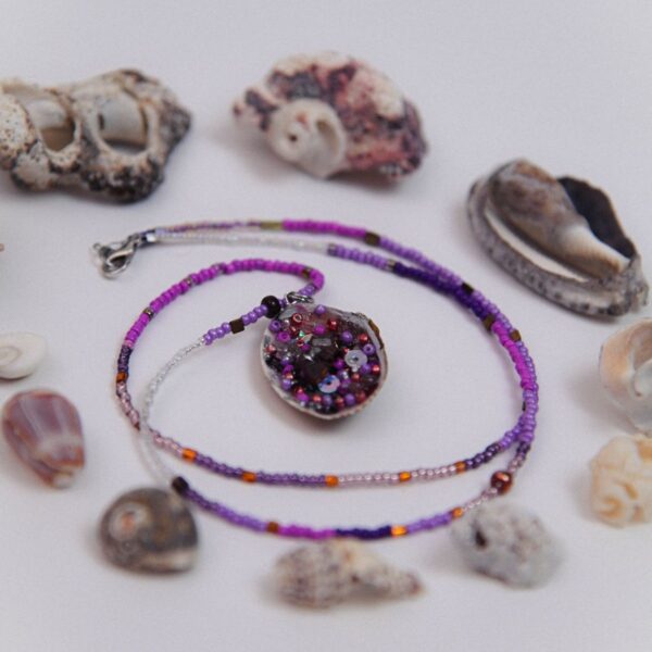 Purple bead necklace with stone pendant